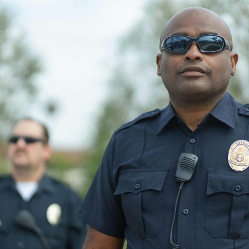 Police officers standing outdoors ensuring public safety. Law enforcement teamwork and professionalism.